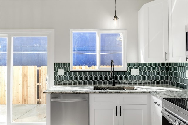 kitchen with a sink, stainless steel dishwasher, white cabinetry, decorative backsplash, and light stone countertops