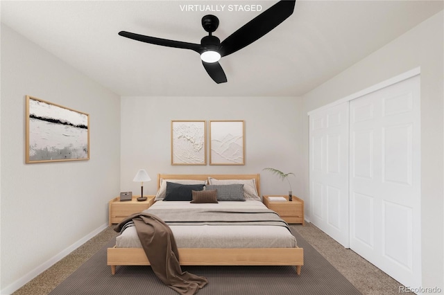 carpeted bedroom with a closet, baseboards, and a ceiling fan