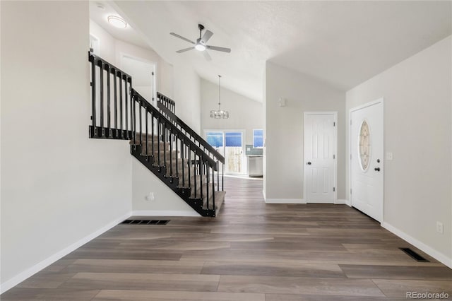 entrance foyer featuring baseboards, high vaulted ceiling, wood finished floors, and stairs