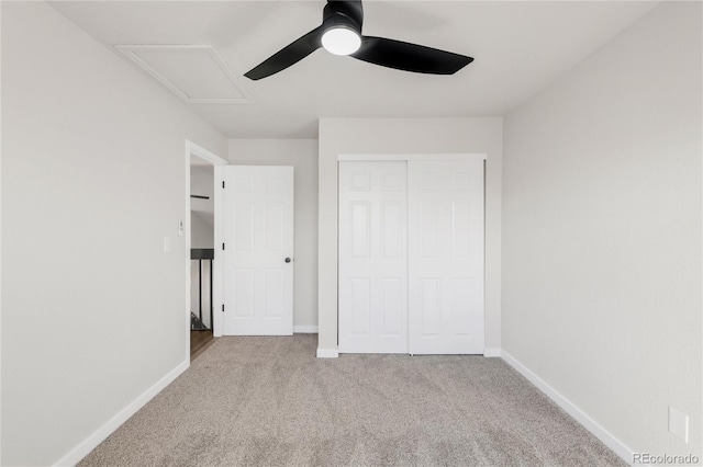 unfurnished bedroom featuring a closet, carpet flooring, a ceiling fan, and baseboards