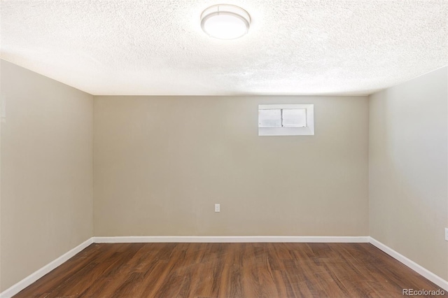 448 K Ave, Limon, CO 80828 - basement featuring dark wood-type flooring, a textured ceiling, and baseboards