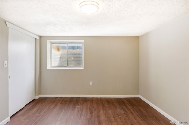 448 K Ave, Limon, CO 80828 - unfurnished room with wood finished floors, a textured ceiling, and baseboards