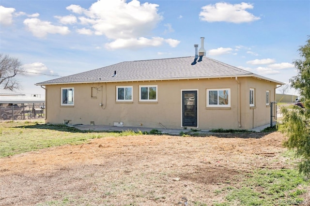448 K Ave, Limon, CO 80828 - rear view of house with fence, stucco siding, and roof with shingles