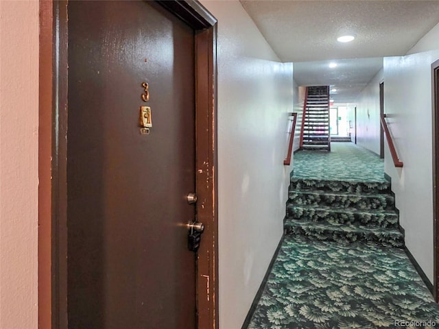 9650 Huron St Unit 3, Thornton, CO 80260 - hall featuring carpet floors, stairs, and a textured ceiling