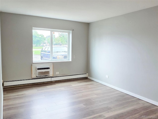 9650 Huron St Unit 3, Thornton, CO 80260 - empty room featuring baseboard heating, light wood-style flooring, and a wall unit AC