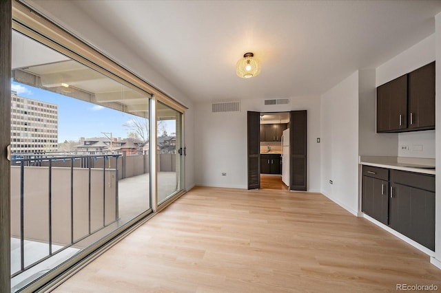 700 N Washington St Unit 402, Denver, CO 80203 - unfurnished dining area featuring light wood-style floors and baseboards
