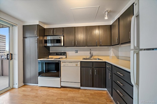 700 N Washington St Unit 402, Denver, CO 80203 - kitchen featuring white appliances, light countertops, dark brown cabinets, and light wood-style flooring