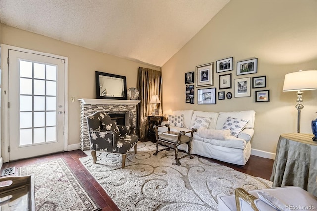 2238 S Nome Ct, Aurora, CO 80014 - living area featuring wood finished floors, high vaulted ceiling, and a tiled fireplace