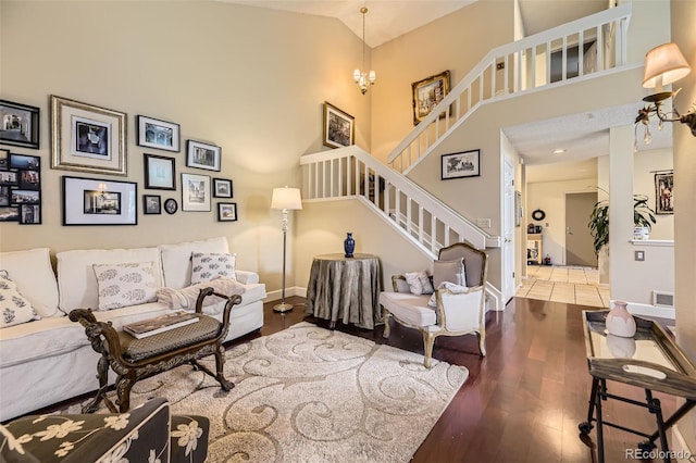 2238 S Nome Ct, Aurora, CO 80014 - living area featuring high vaulted ceiling, stairs, and wood finished floors