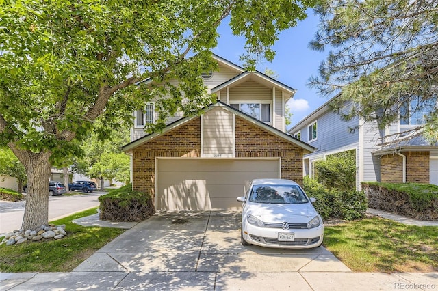 2238 S Nome Ct, Aurora, CO 80014 - view of front facade with concrete driveway, brick siding, and a garage