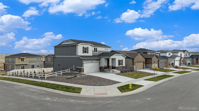 traditional-style home featuring a residential view, stone siding, concrete driveway, fence, and an attached garage