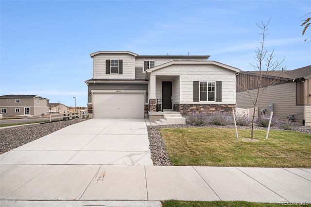 view of front of property with stone siding, an attached garage, a front lawn, and driveway