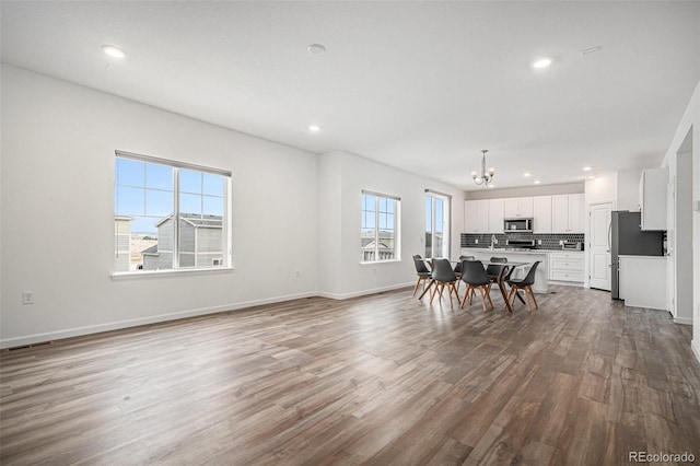 dining area with recessed lighting, wood finished floors, visible vents, baseboards, and a chandelier