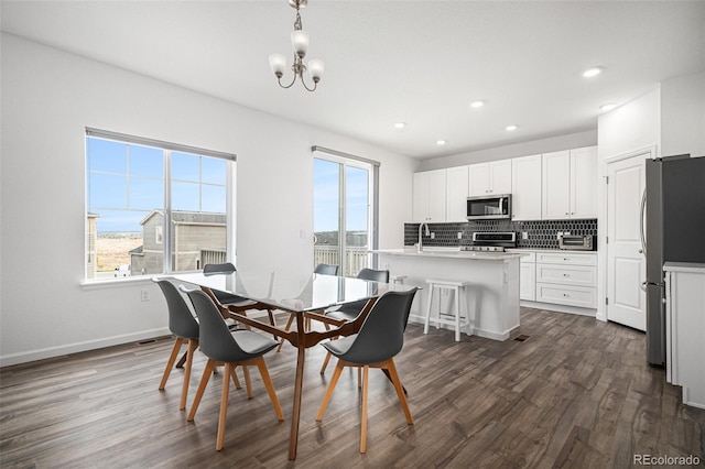 dining room featuring baseboards, recessed lighting, a notable chandelier, and dark wood-style flooring