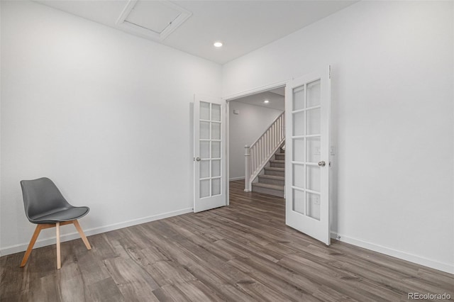 spare room featuring attic access, french doors, baseboards, recessed lighting, and wood finished floors