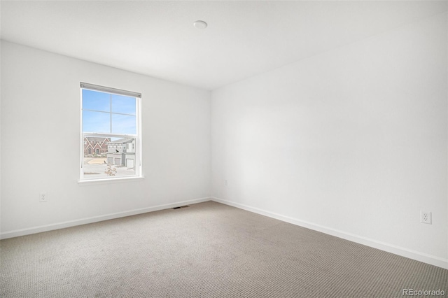 carpeted empty room with baseboards and visible vents