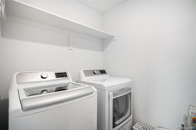 washroom featuring separate washer and dryer and laundry area