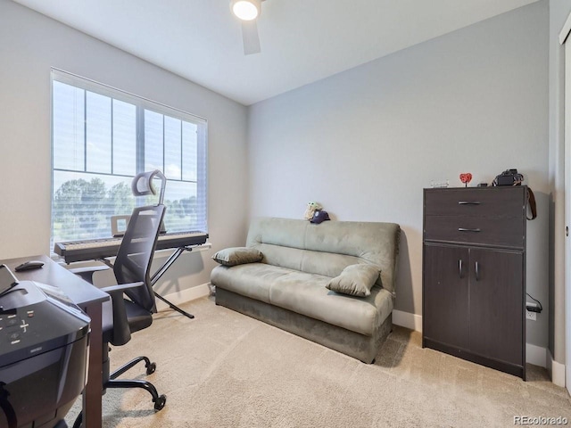 office area featuring light carpet and ceiling fan