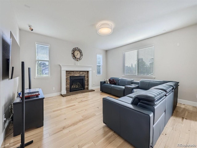 living room featuring a fireplace and light wood-type flooring