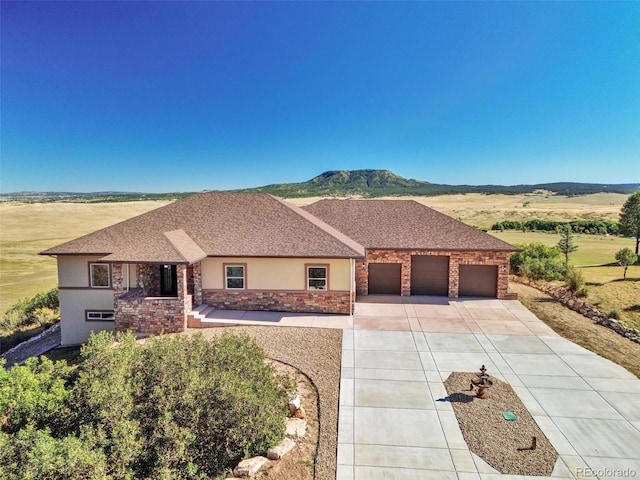 single story home featuring a garage and a mountain view