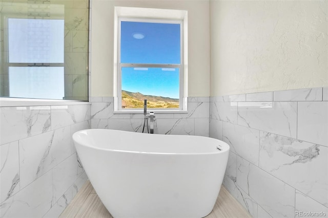 bathroom with a tub to relax in