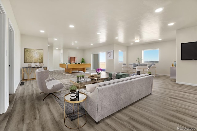 living room with billiards and light hardwood / wood-style floors