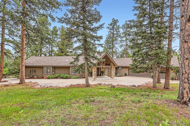 4856 Cheyenne Dr, Larkspur, CO 80118 - back of house featuring driveway, a lawn, and roof with shingles