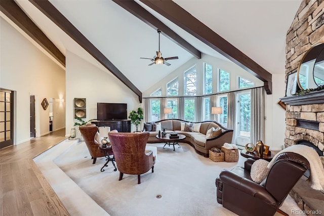 4856 Cheyenne Dr, Larkspur, CO 80118 - living area featuring high vaulted ceiling, beam ceiling, a fireplace, a ceiling fan, and wood finished floors