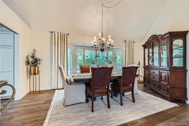 4856 Cheyenne Dr, Larkspur, CO 80118 - dining area featuring a chandelier, wood finished floors, and lofted ceiling
