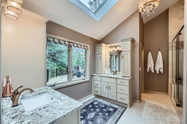 4856 Cheyenne Dr, Larkspur, CO 80118 - bathroom featuring vanity, tiled shower, vaulted ceiling, a chandelier, and tile patterned floors