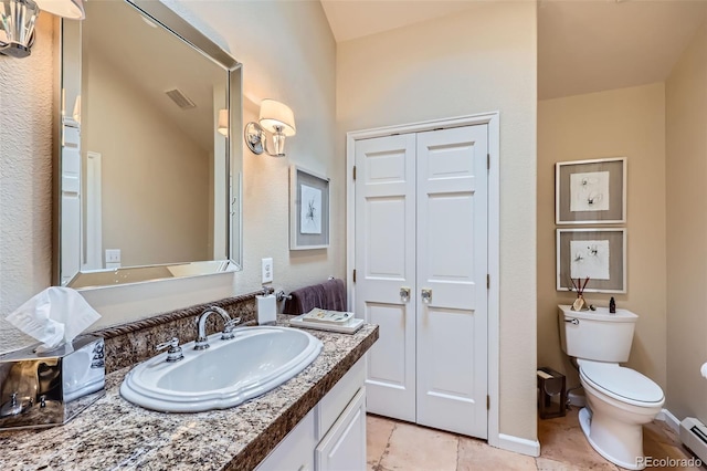 4856 Cheyenne Dr, Larkspur, CO 80118 - bathroom featuring a baseboard radiator, vanity, toilet, and tile patterned floors