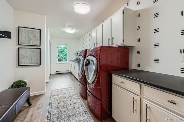 4856 Cheyenne Dr, Larkspur, CO 80118 - washroom featuring a baseboard heating unit, cabinet space, washer and dryer, light wood finished floors, and baseboards