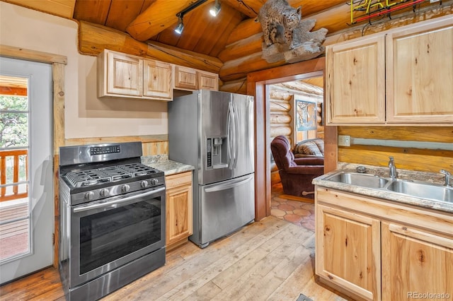 780 Oak St, Hartsel, CO 80449 - kitchen with appliances with stainless steel finishes, light brown cabinets, rustic walls, track lighting, and light wood-style floors
