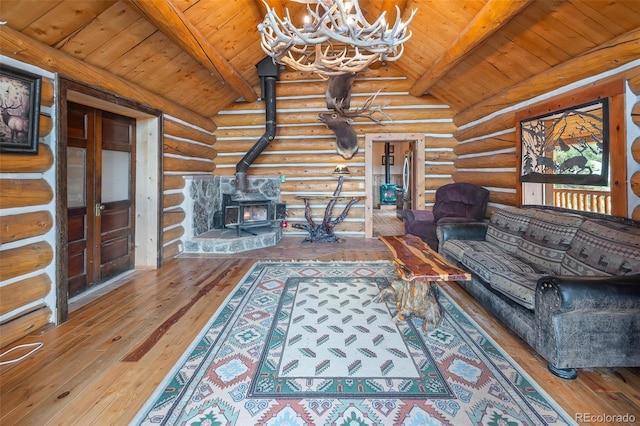 780 Oak St, Hartsel, CO 80449 - living room with rustic walls, a wood stove, a chandelier, wood-type flooring, and wooden ceiling