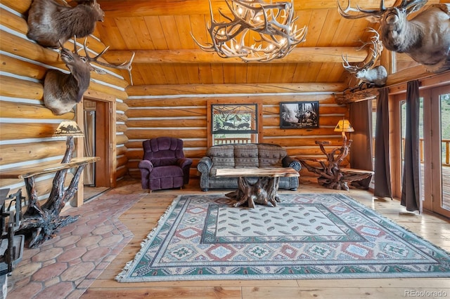 780 Oak St, Hartsel, CO 80449 - sitting room featuring wooden ceiling, a chandelier, rustic walls, and hardwood / wood-style flooring