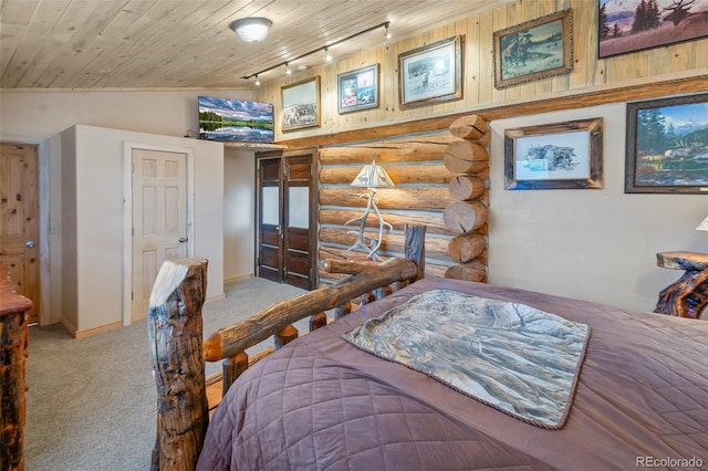 780 Oak St, Hartsel, CO 80449 - bedroom with track lighting, log walls, carpet, wood ceiling, and lofted ceiling