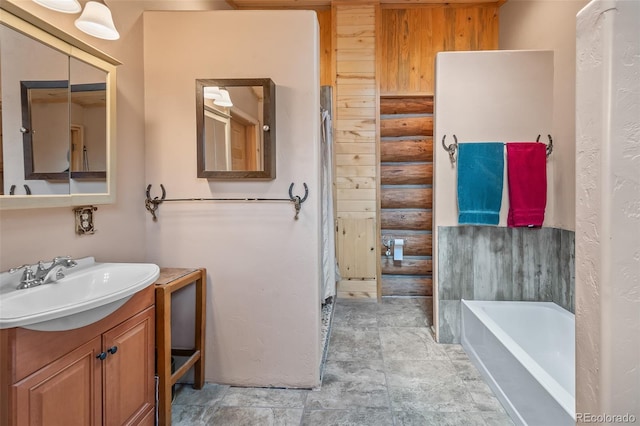 780 Oak St, Hartsel, CO 80449 - bathroom with vanity, a bath, log walls, and stone finish floors