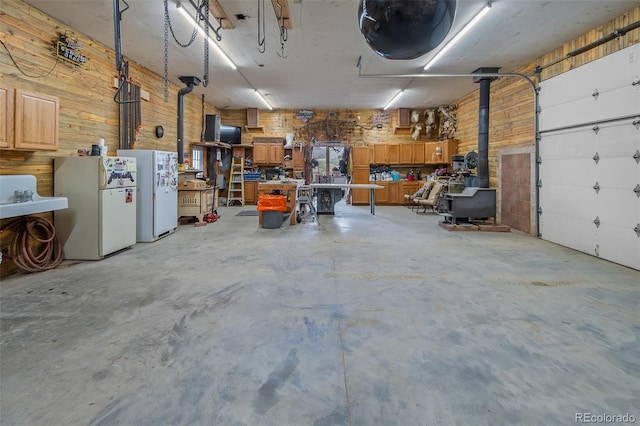 780 Oak St, Hartsel, CO 80449 - garage with freestanding refrigerator, wooden walls, and a workshop area