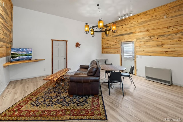 780 Oak St, Hartsel, CO 80449 - living area with wood walls, wood finished floors, a chandelier, heating unit, and track lighting