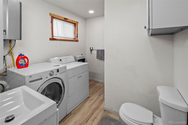 780 Oak St, Hartsel, CO 80449 - laundry area featuring washing machine and clothes dryer, light wood finished floors, tankless water heater, and recessed lighting