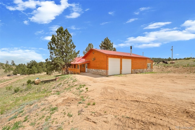 780 Oak St, Hartsel, CO 80449 - view of property exterior with stone siding and a garage