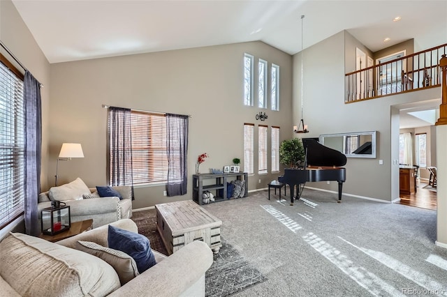 carpeted living room with high vaulted ceiling