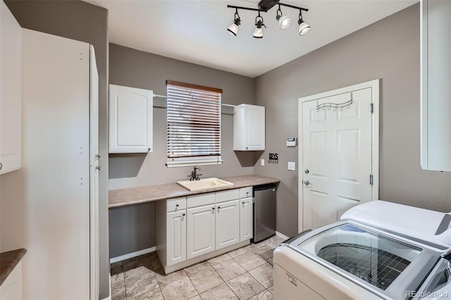 washroom featuring sink, cabinets, and washer and dryer