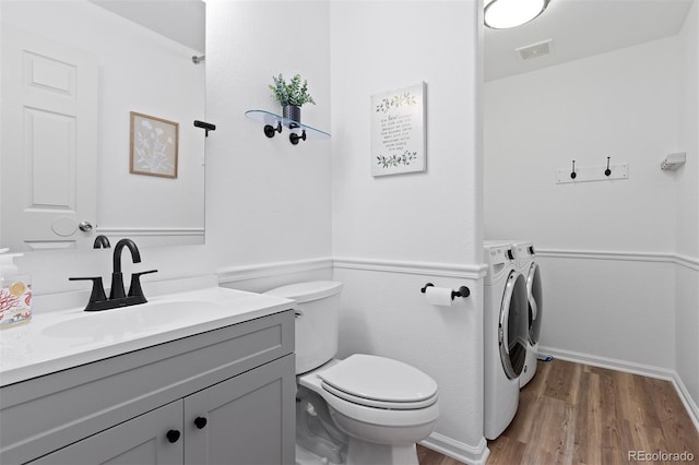 2763 Dharma Ave, Broomfield, CO 80020 - half bathroom featuring wood finished floors, vanity, and independent washer and dryer