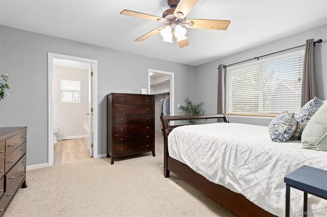 2763 Dharma Ave, Broomfield, CO 80020 - bedroom featuring a spacious closet, light colored carpet, ensuite bath, and ceiling fan