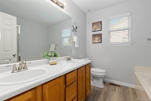 2763 Dharma Ave, Broomfield, CO 80020 - bathroom with double vanity, a bath, and wood finished floors