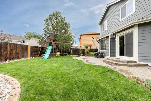 2763 Dharma Ave, Broomfield, CO 80020 - fenced backyard with a patio area and a playground