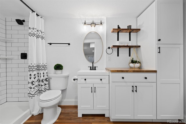 2763 Dharma Ave, Broomfield, CO 80020 - full bathroom with vanity, tiled shower, and wood finished floors