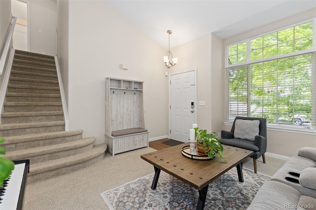 2763 Dharma Ave, Broomfield, CO 80020 - living area with stairway, plenty of natural light, a chandelier, carpet floors, and high vaulted ceiling