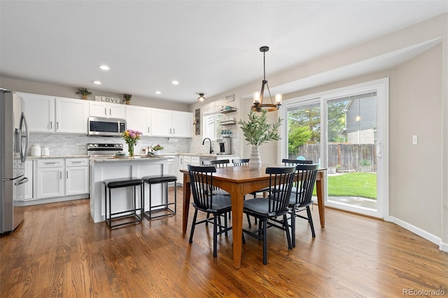 2763 Dharma Ave, Broomfield, CO 80020 - dining room with dark wood-type flooring, recessed lighting, and a chandelier